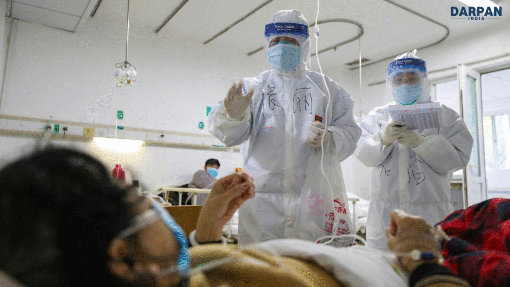 Doctors in full protective suits and face shields attending to patients in a hospital ward in china